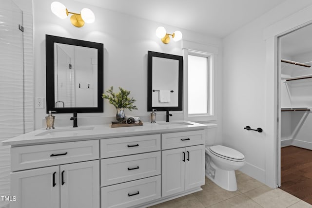 bathroom featuring vanity, an enclosed shower, tile patterned floors, and toilet