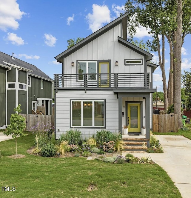 view of front of home featuring a balcony and a front lawn