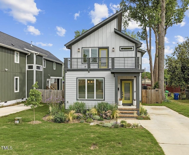 view of front of property featuring a front lawn and a balcony