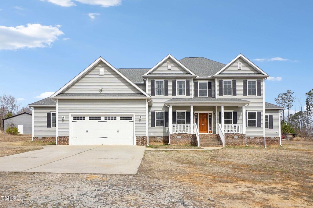 7880 Flower Hill Rd, Middlesex, NC 27557 - view of front of home featuring an attached garage, covered porch, driveway, and crawl space