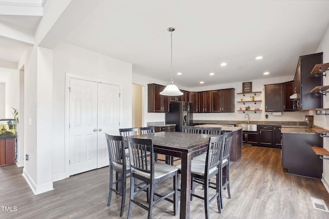 dining room with recessed lighting, visible vents, baseboards, and wood finished floors