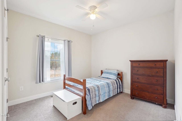 bedroom with light carpet, ceiling fan, and baseboards