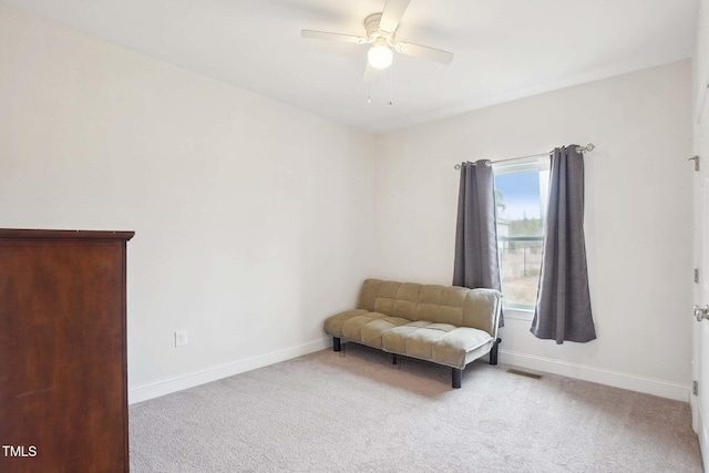 sitting room featuring light carpet, ceiling fan, visible vents, and baseboards