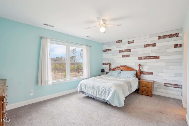 bedroom featuring carpet floors, a ceiling fan, visible vents, and baseboards