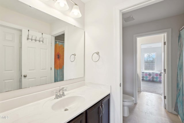 bathroom featuring vanity and toilet