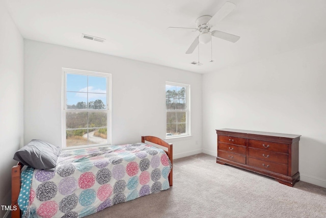 bedroom with ceiling fan, carpet floors, visible vents, and baseboards