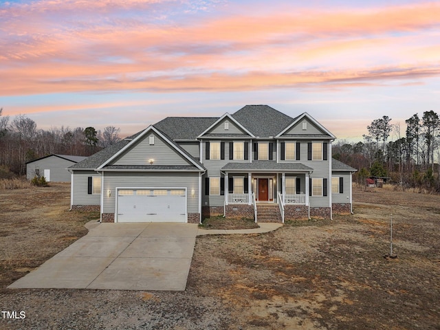 view of front of home with a shingled roof, covered porch, an attached garage, and concrete driveway