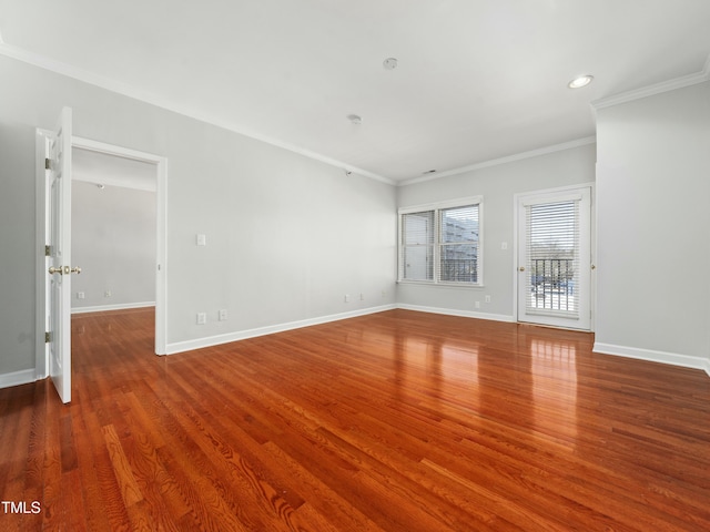 empty room with ornamental molding, recessed lighting, baseboards, and wood finished floors