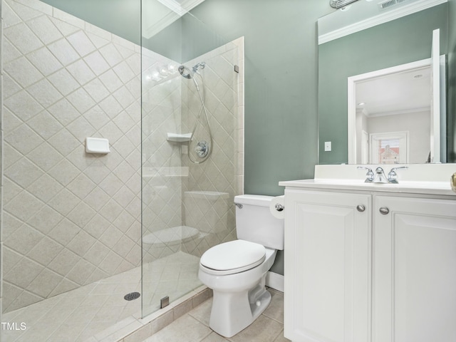 bathroom with crown molding, toilet, a tile shower, vanity, and tile patterned flooring