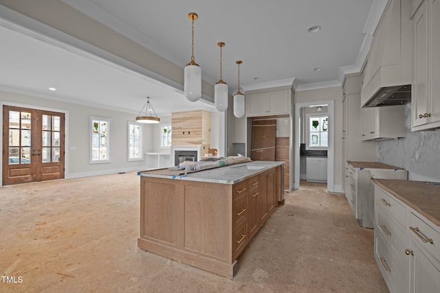 kitchen with a healthy amount of sunlight, a fireplace, and ornamental molding