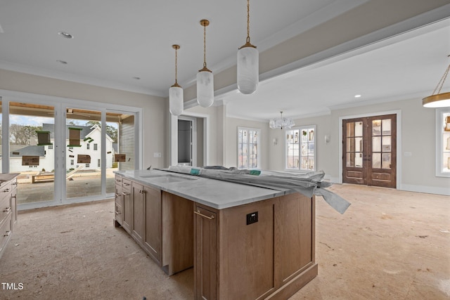 kitchen with ornamental molding, french doors, plenty of natural light, and open floor plan