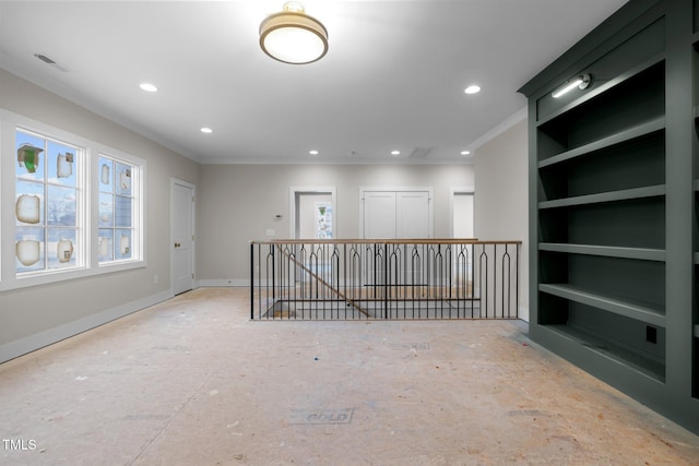 empty room with baseboards, built in features, ornamental molding, and recessed lighting