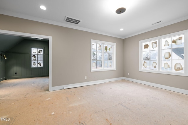 empty room with visible vents, crown molding, and baseboards