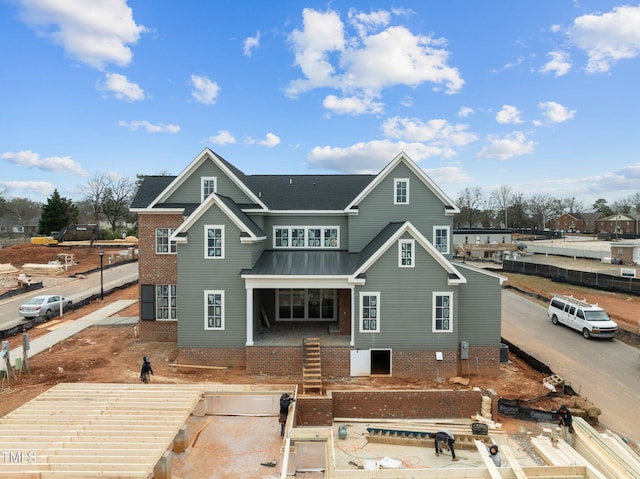 back of house featuring metal roof and a standing seam roof