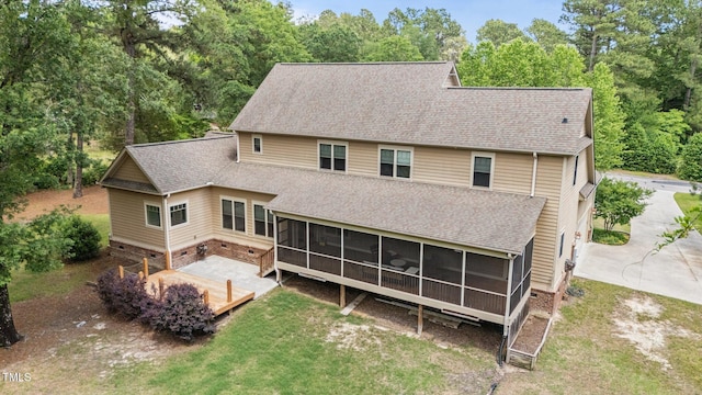 145 Vinca Dr, Carthage, NC 28327 - rear view of house featuring a sunroom, a shingled roof, a lawn, crawl space, and view of scattered trees
