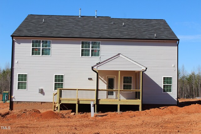 rear view of house featuring a wooden deck