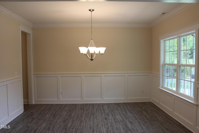 unfurnished dining area with crown molding, a wealth of natural light, a notable chandelier, and dark hardwood / wood-style flooring