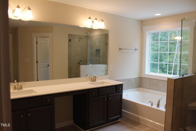 bathroom with vanity and separate shower and tub