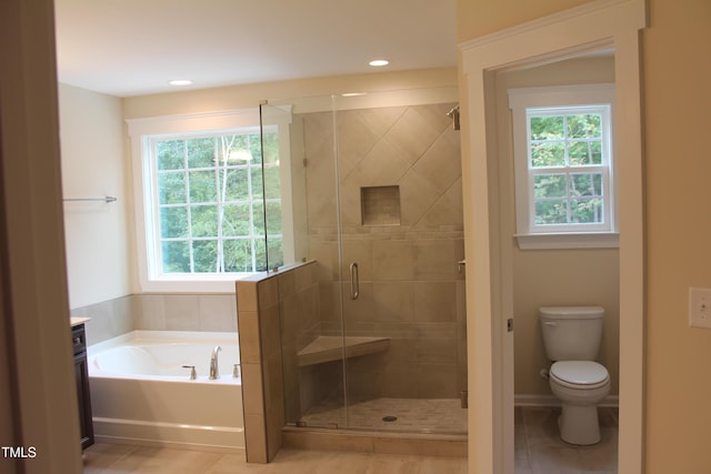 bathroom with toilet, shower with separate bathtub, and tile patterned flooring