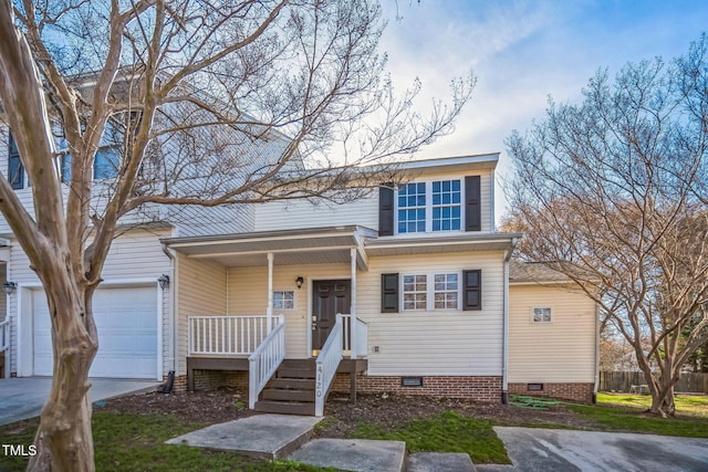 traditional home with driveway, crawl space, and an attached garage