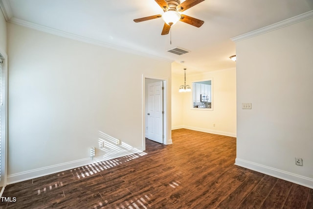 empty room with ornamental molding, visible vents, baseboards, dark wood finished floors, and ceiling fan with notable chandelier