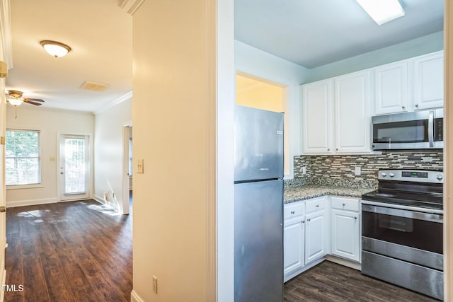 kitchen with white cabinetry, appliances with stainless steel finishes, dark wood-style flooring, and backsplash