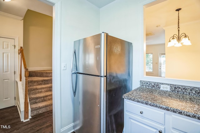 kitchen featuring freestanding refrigerator, crown molding, dark wood finished floors, pendant lighting, and white cabinets