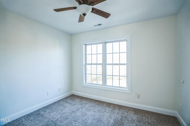 spare room featuring baseboards, ceiling fan, visible vents, and carpet floors
