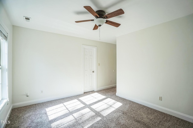 unfurnished room featuring light colored carpet, visible vents, and baseboards