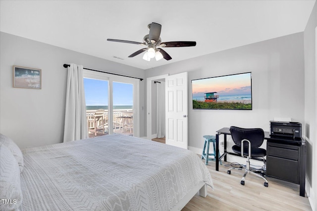 bedroom featuring light hardwood / wood-style floors, ceiling fan, and access to outside