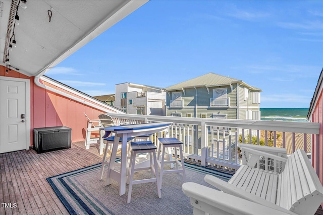 balcony with a water view and a beach view