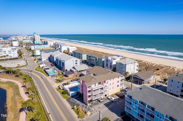 drone / aerial view featuring a water view and a view of the beach