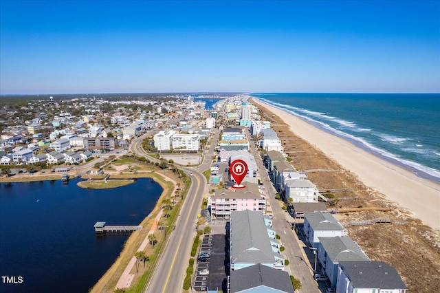 birds eye view of property featuring a water view and a view of the beach