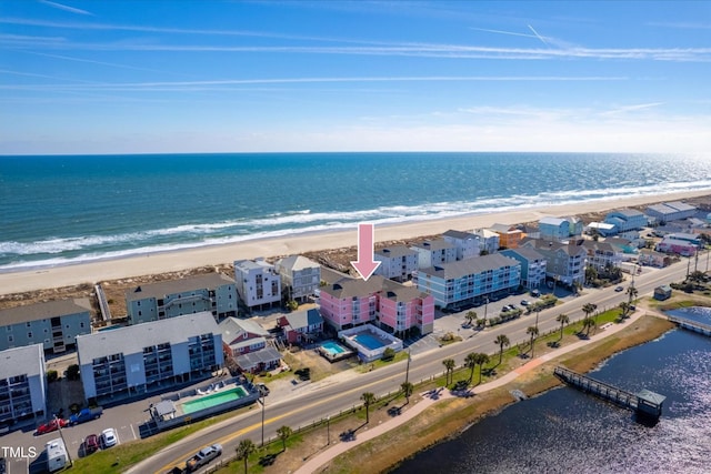 drone / aerial view with a beach view and a water view