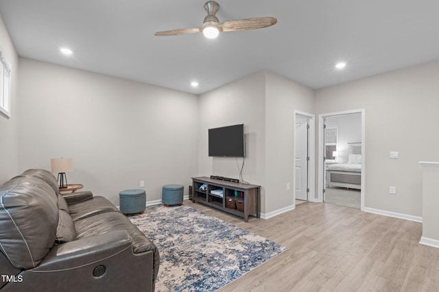 living room featuring baseboards, recessed lighting, a ceiling fan, and light wood-style floors