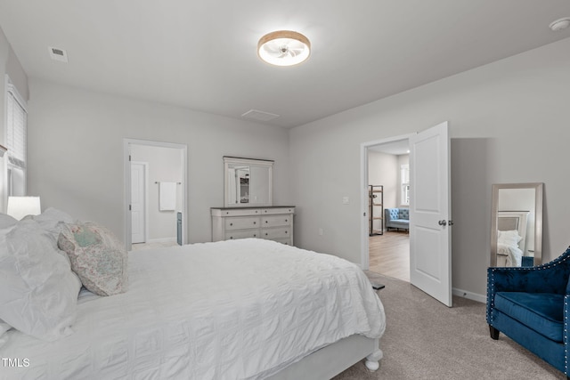 bedroom featuring light carpet, visible vents, and baseboards