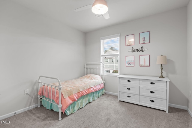 bedroom featuring light carpet, baseboards, and a ceiling fan