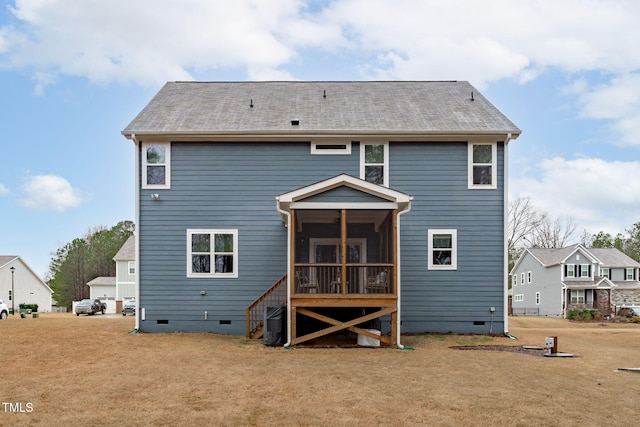 back of house with a sunroom, crawl space, and a lawn