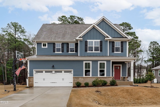 craftsman-style house with board and batten siding, concrete driveway, brick siding, and an attached garage