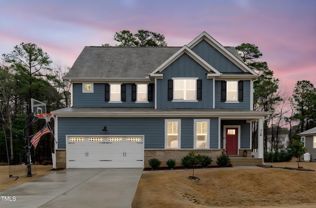 craftsman-style home with board and batten siding, brick siding, driveway, and a garage