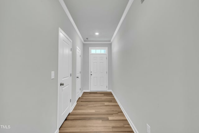 entryway featuring light wood-type flooring and crown molding