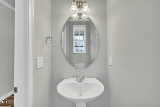 bathroom featuring sink, hardwood / wood-style floors, and an inviting chandelier