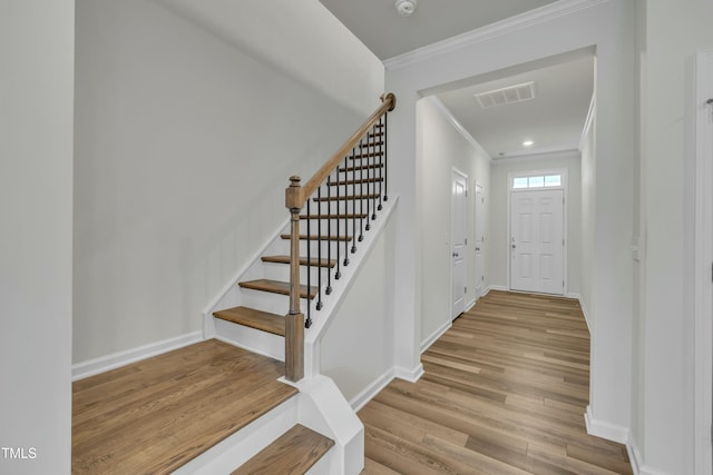 foyer featuring light hardwood / wood-style flooring and ornamental molding