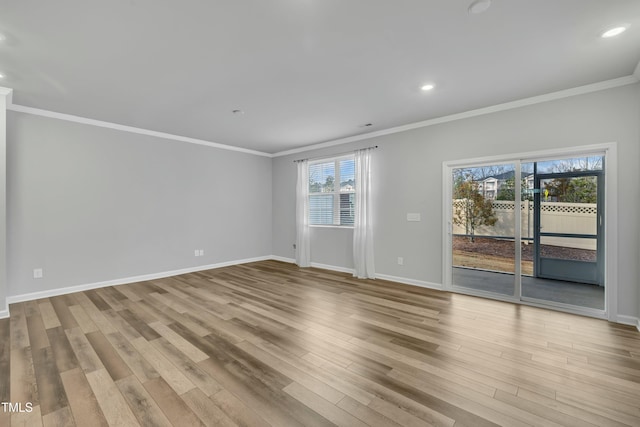 unfurnished room with light wood-type flooring and crown molding