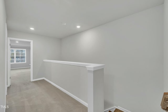 hallway with light colored carpet