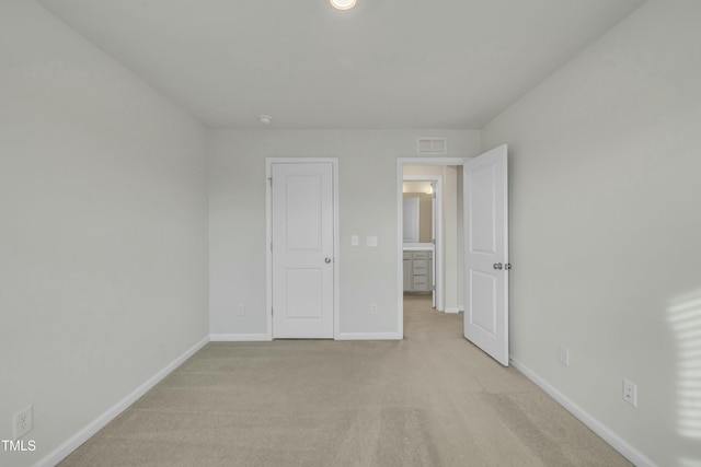 unfurnished bedroom with light colored carpet