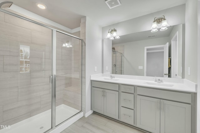 bathroom featuring vanity and a shower with door