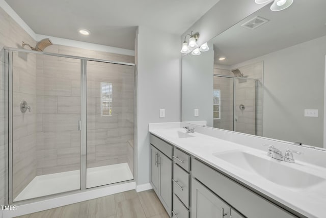 bathroom with an enclosed shower and vanity