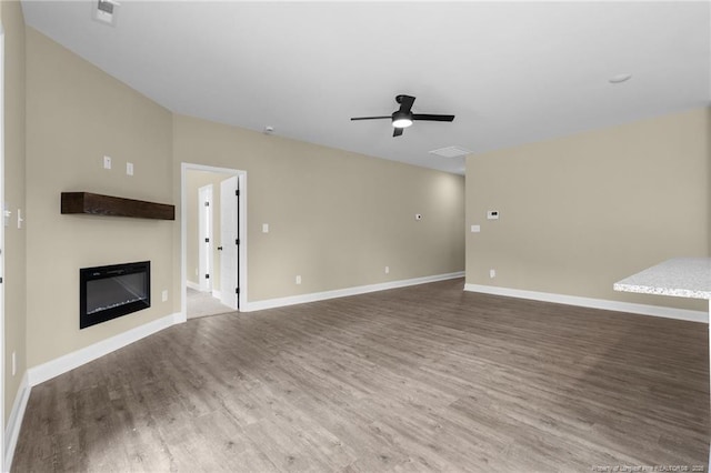 unfurnished living room featuring hardwood / wood-style flooring and ceiling fan