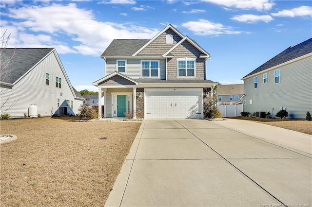 craftsman-style house featuring a garage and a front yard